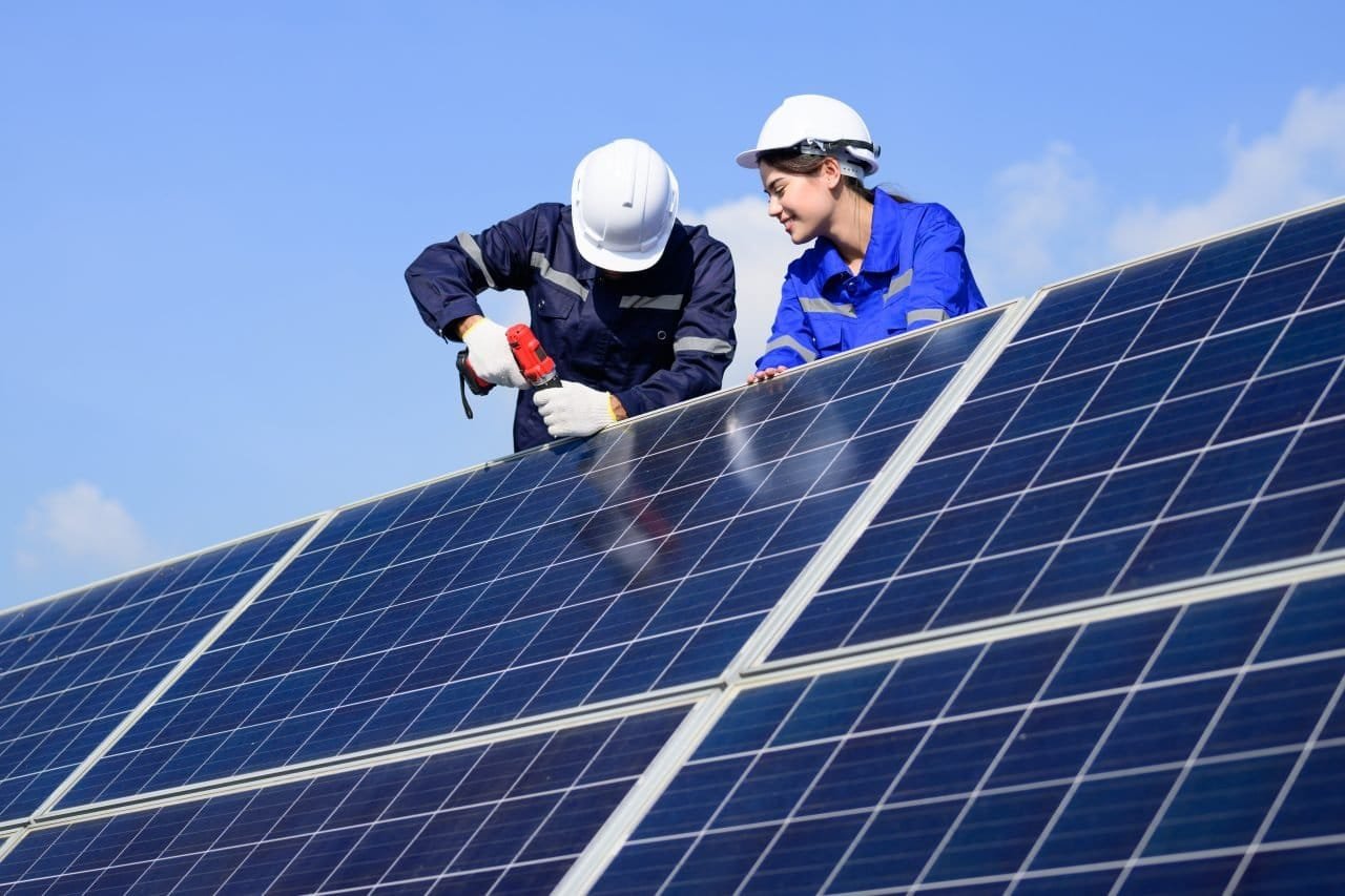 technicians installing solar panels on a Sheffield roof.